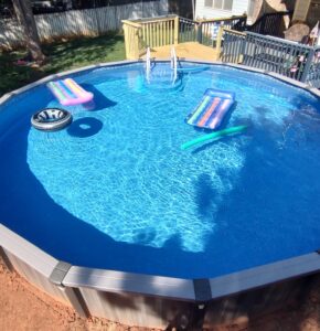 Above ground pool with floats inside.