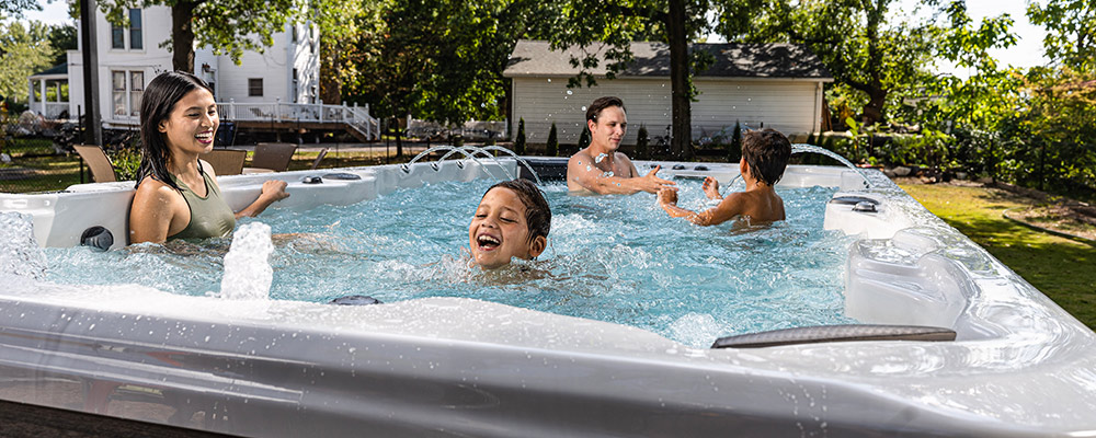 a young family playing in a hot tub